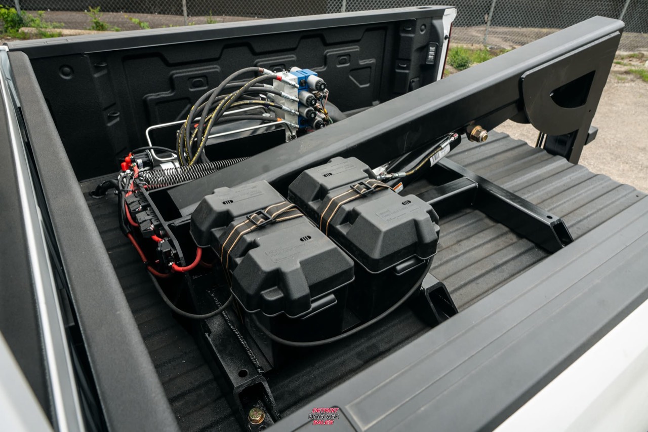 Baby Gladiator frame, hydraulic system and battery enclosures installed in a pickup bed.