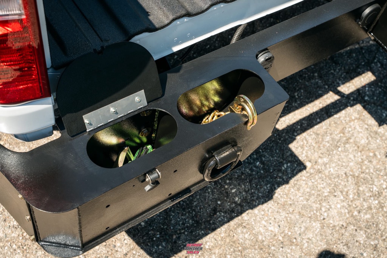 Optional rear bumper with storage compartments for chains and recovery gear.