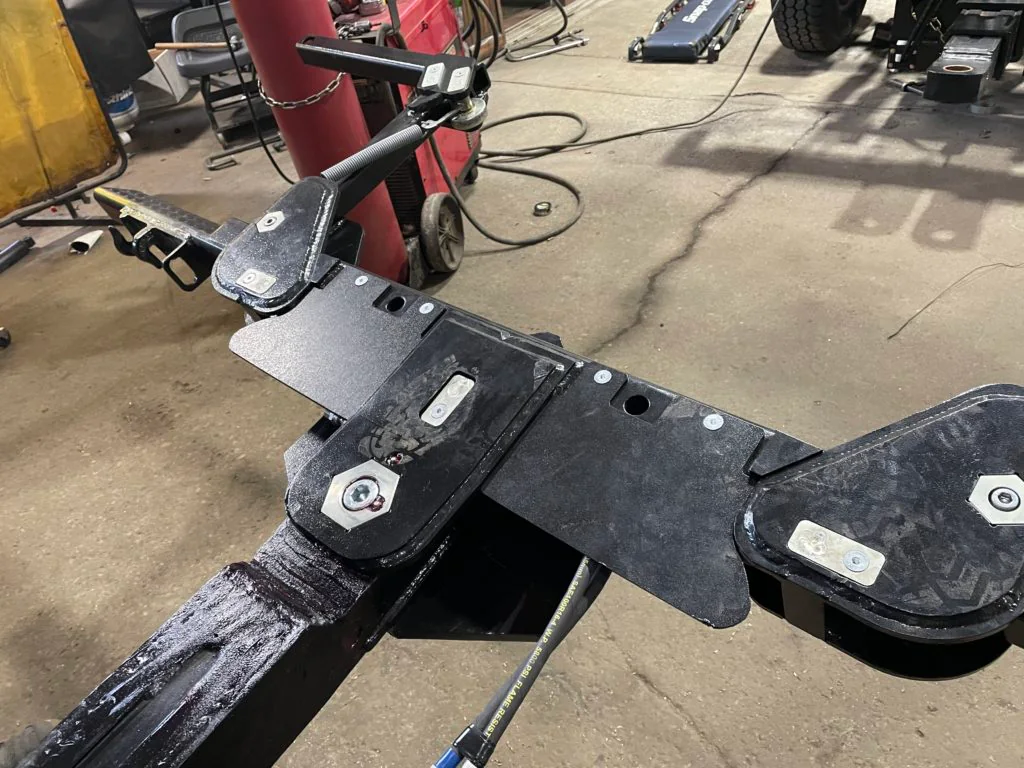 Protective cover plates fitted over the hydraulics of a Detroit Wrecker crossbar.