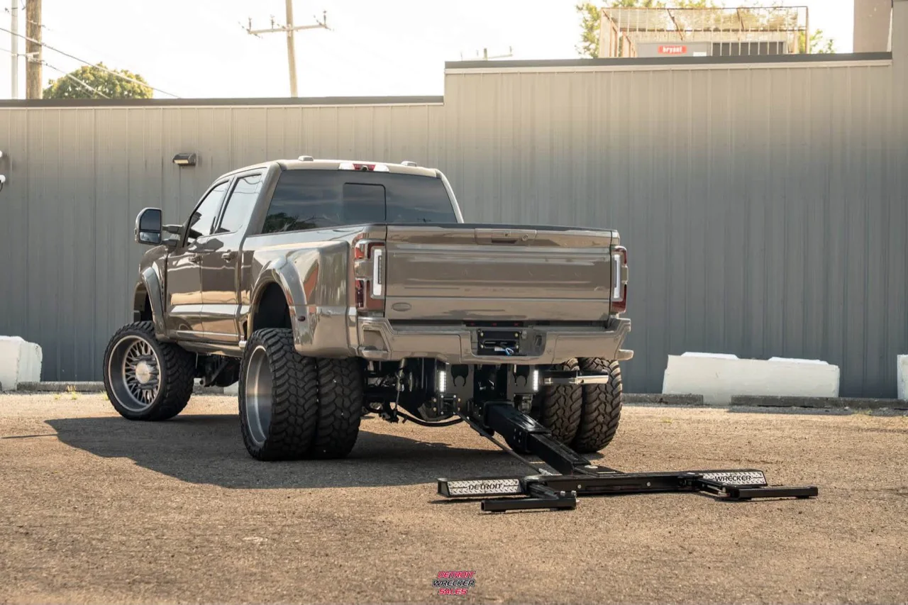 Lil Hercules wheel lift extended beneath the rear of a Ford dually pickup.